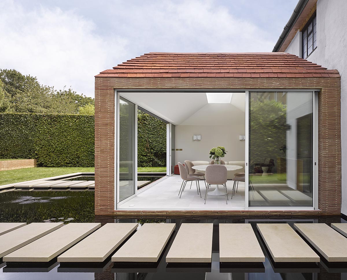 Ketley creasing tiles and Dreadnought deep red handmade roof tiles at Metroland by Dominic Mckenzie Architects